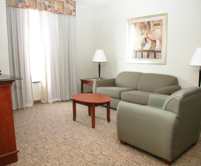Quiet hotel sitting area with sofa and soft lighting that could be designated as a low-stimulus space during sports events