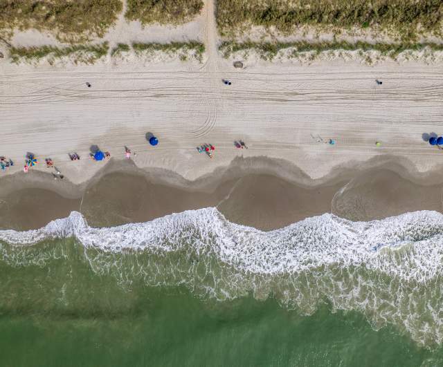 An aerial view of waves and the beach in North Myrtle Beach