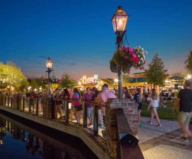 Crowd Walking Barefoot Walkway at Night