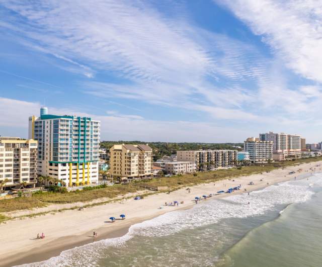 A shoreline view of Crescent Beach with lots of oceanfront resorts.