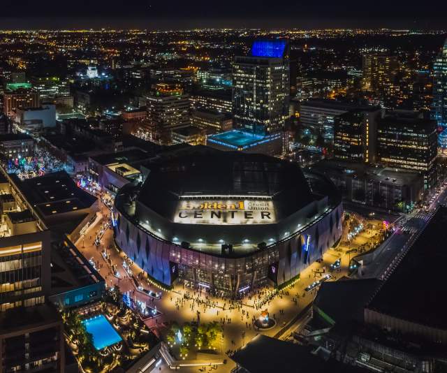 Aerial view at night of Golden1 Center, the Kimpton, and the downtown skyline.