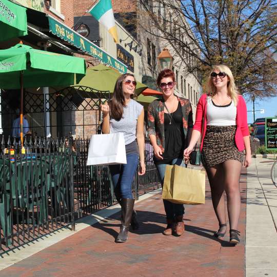 Woman walking downtown carrying shopping bags
