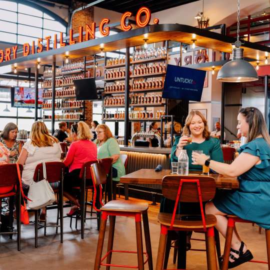 People enjoying food and drinks at the restaurant at Old Glory.