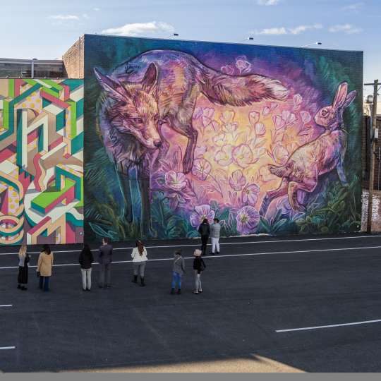a group of people admiring a mural at Mural Park in the Royal Square District of Downtown York