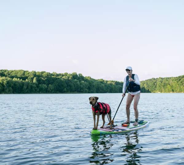 A girl paddle boarding with her dog at Freeman Lake Park