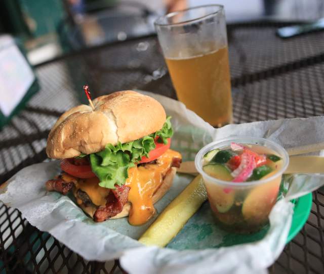 Bacon Cheeseburger, pickle spear, cup of tomato and cucumber salad