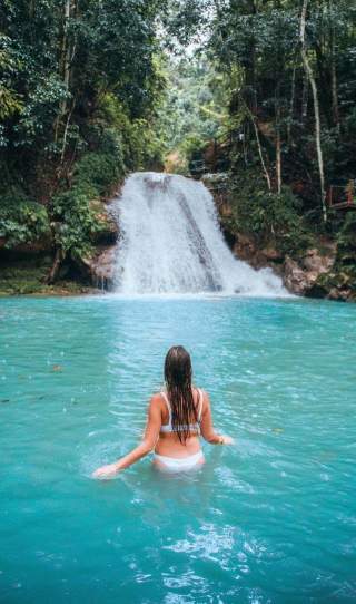 Woman in front of a waterfall