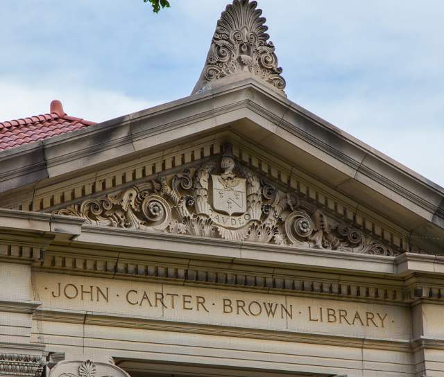 Close-up of the ornate neoclassical facade and pediment of the John Carter Brown Library with carved stone details in Providence, Rhode Island.