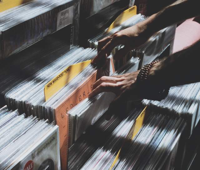 Man sorting through a collection of vinyl records