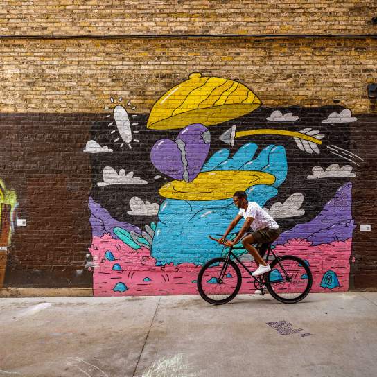 man biking through Black Cat Alley
