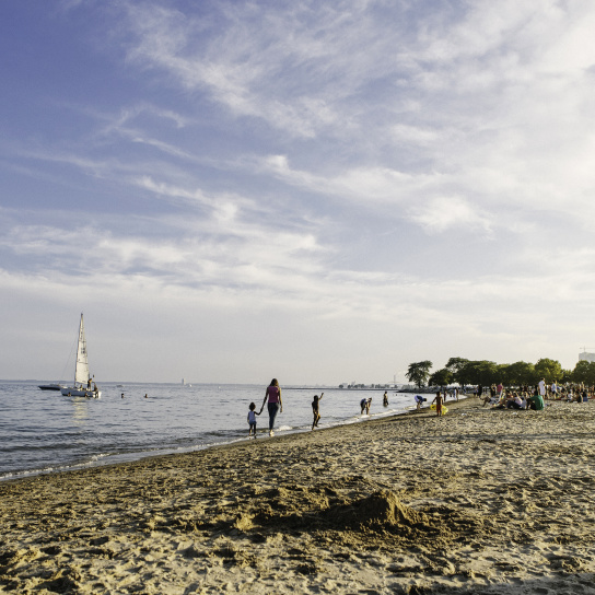 wide view of Bradford Beach, boats and people in the water