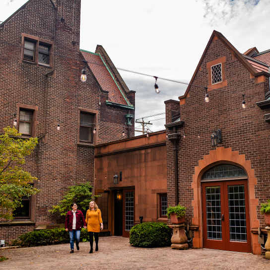 couple walking and holding hands in courtyard