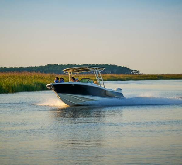 A motorboat cruises through the serene marshes and waterways along St. Simons Island, GA