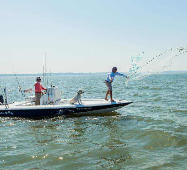 Friends spend an afternoon fishing on the water fishing in the Atlantic Ocean near St. Simons Island, Georgia