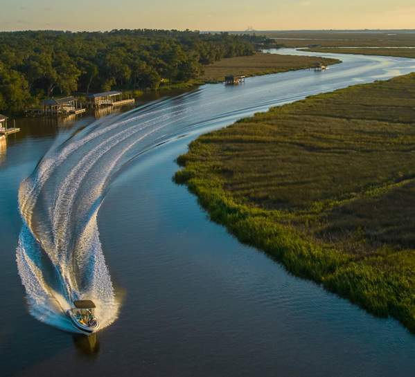 A boat navigates the marshes and waterways in the Golden Isles.