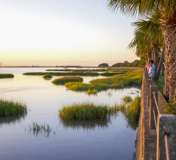 A couple takes in the sunset along the Jekyll Island Riverfront near the Jekyll Island Club Resort