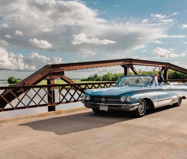 Classic car driving over Lake Overholser along Route 66
