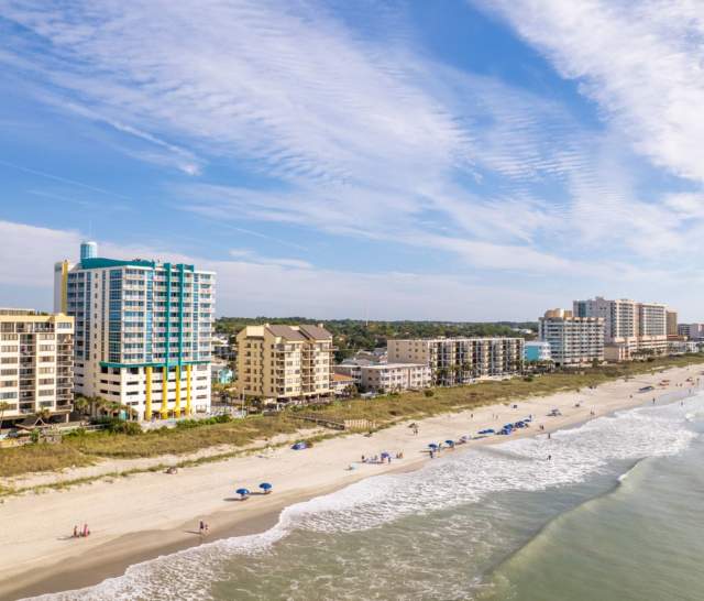 A shoreline view of Crescent Beach with lots of oceanfront resorts.