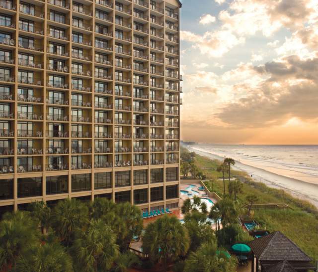an oceanfront beach resort at dusk