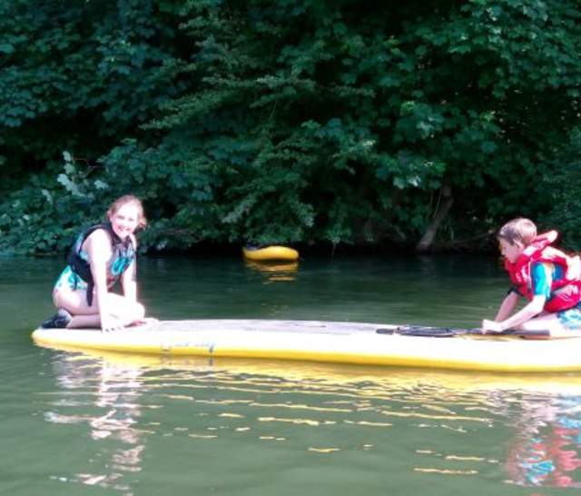 Two children on a paddleboard on the Thames