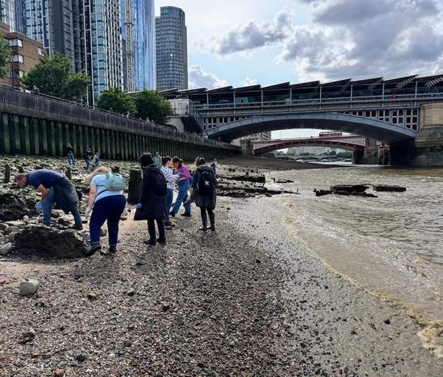 View of mudlarkers on the banks of the Thames in London
