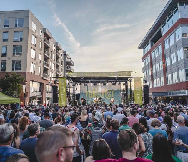 A crowd of people looking at the ForeFest stage in Bridge Park