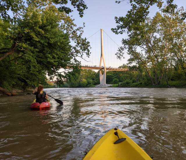 On the water in a kayak with the Dublin Link pedestrian bridge in the distance.