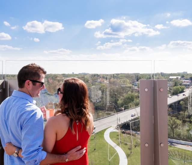 Couple cheersing on the rooptop of VASO overlooking Downtown Dublin
