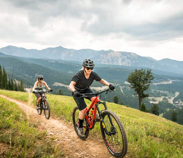 Two girls mountain biking