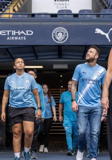 Manchester City Football Club Stadium and Club Tour visitors emerging from the tunnel