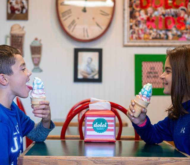 Two kids enjoying ice cream cones from Dolci.