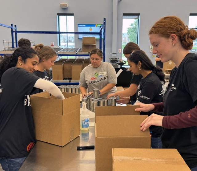 A group of volunteers packaging boxes at the Food Bank for the Heartland.