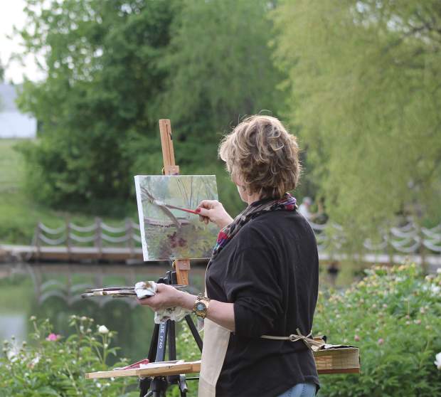 Woman painting in plein air at the Monet Garden at the Overland Park Arboretum and Botanical Gardens