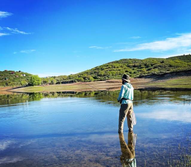 Fisherman fly fishes in one of the lakes on the Grand Mesa