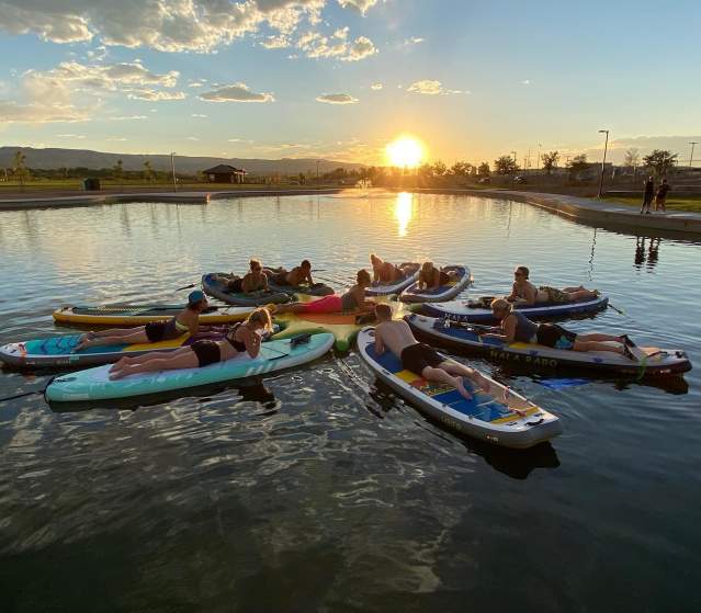 People doing SUP Yoga on Butterfly Lake in Grand Junction
