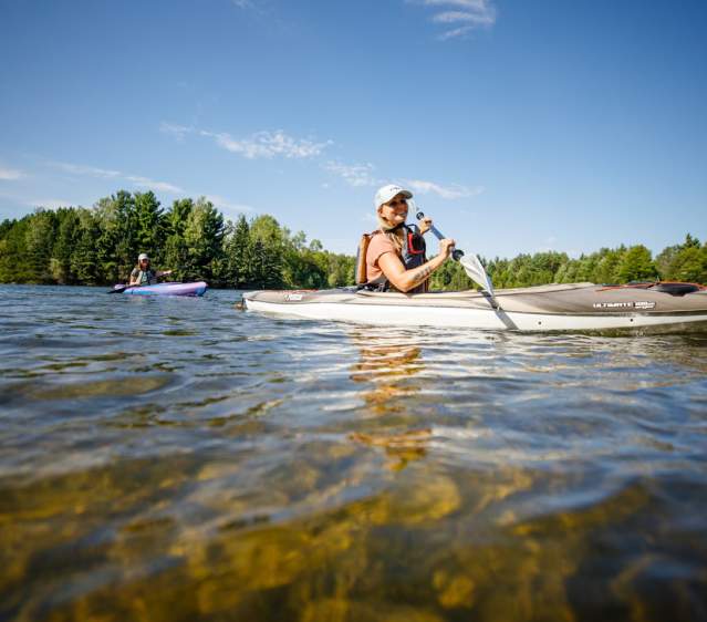 Two women kayaking along the river