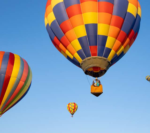 Colorful hot air balloons in the blue day sky