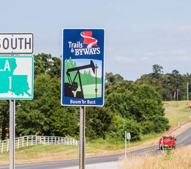 Highway signs along Boom or Bust Byway in northwest Louisiana