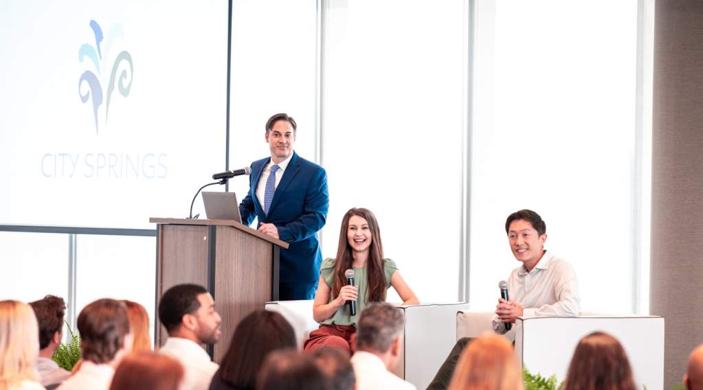 A group listening to a panel on stage