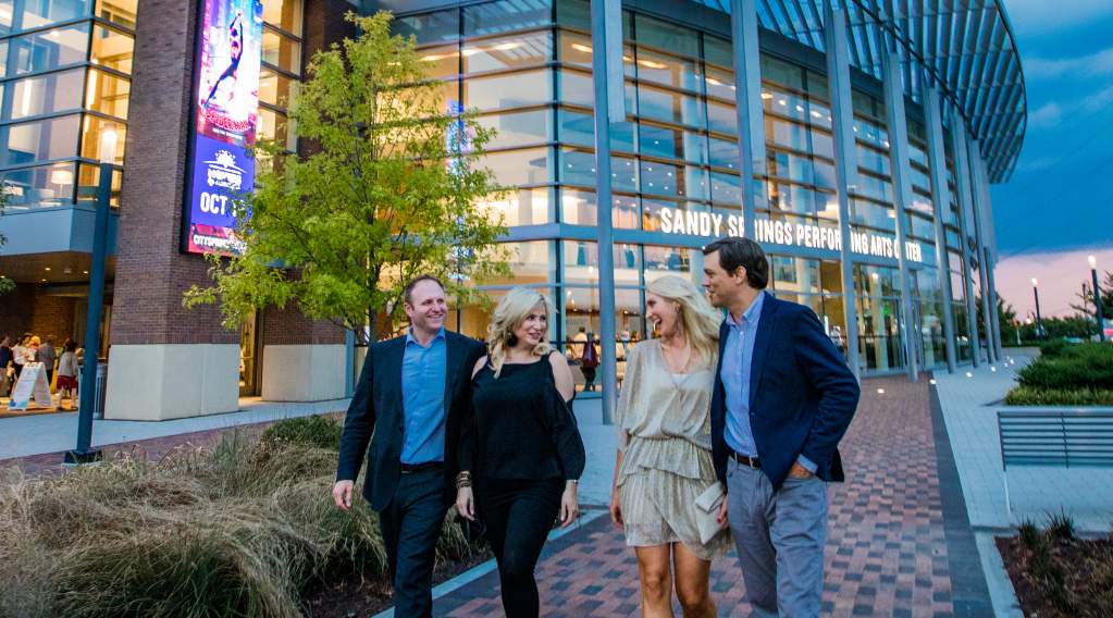 Two couples walking in front of the Sandy Springs Performing Arts Center at City Springs