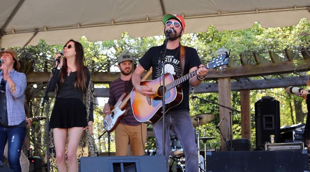 A band performing on stage at Sandy Springs Rhythm & Brews