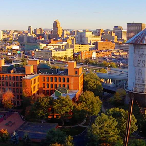 Skyline Photo of Historic Buildings in Downtown Syracuse as Sun Begins to Set