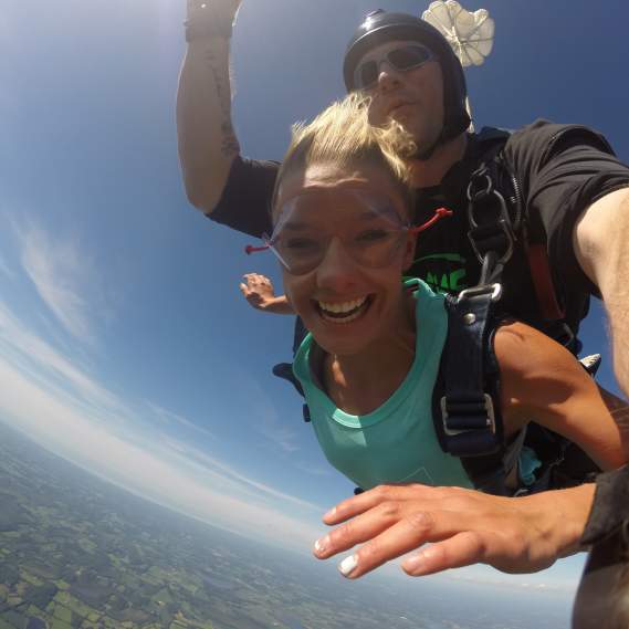 Woman Jumps from Plane with Instructor Attached Behind her