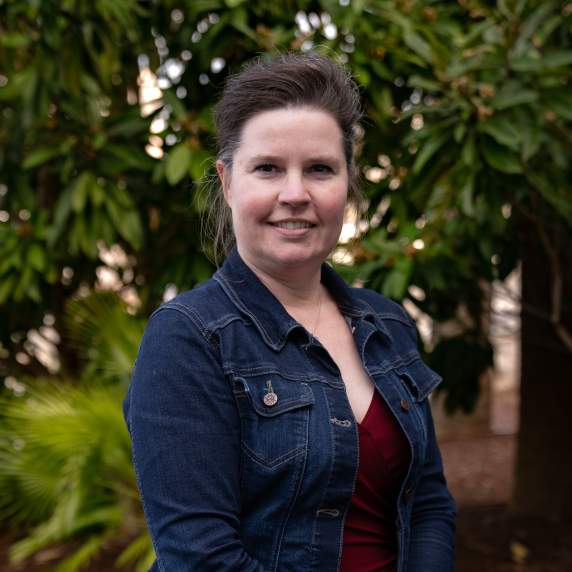 Picture of smiling person with wooded background