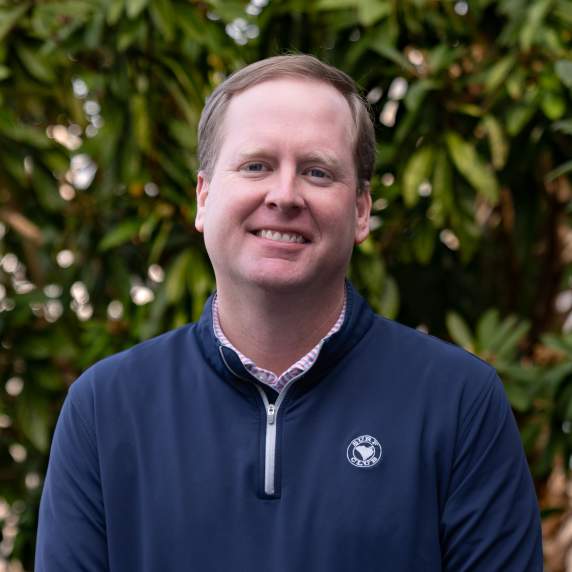 Picture of smiling person with wooded background