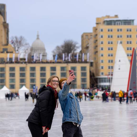 Two people out on the frozen lake taking a selfie during the Frozen Assets Festival on Lake Medonta.