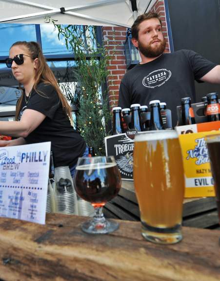 Bartenders serving beer at the Downtown Newark Food + Brew Festival