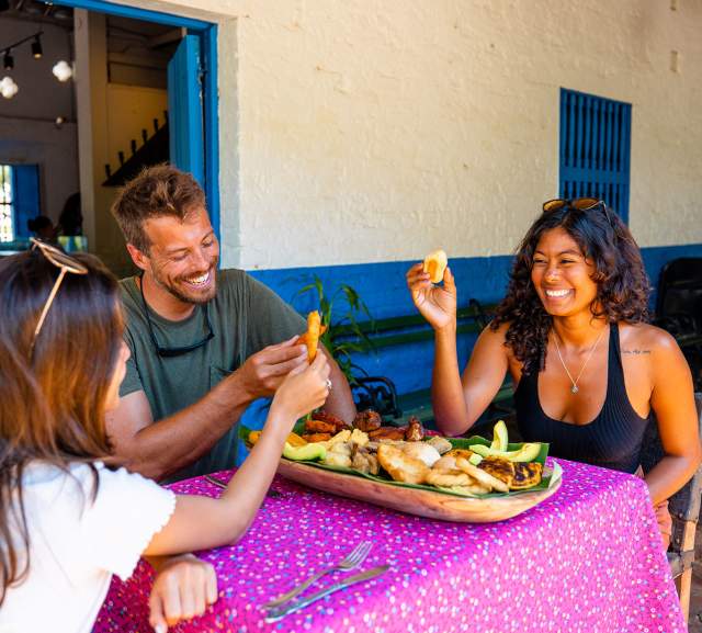 Friends eating Panamanian dish at La Villa de los Santos, Los Santos Province, Panamá