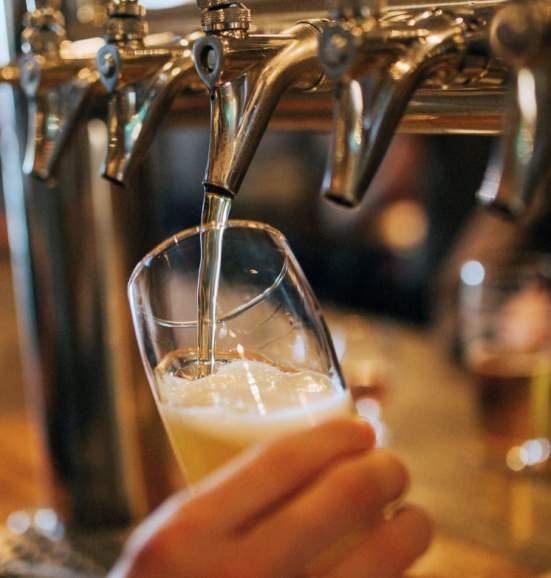 Image of a beer being poured at a bar