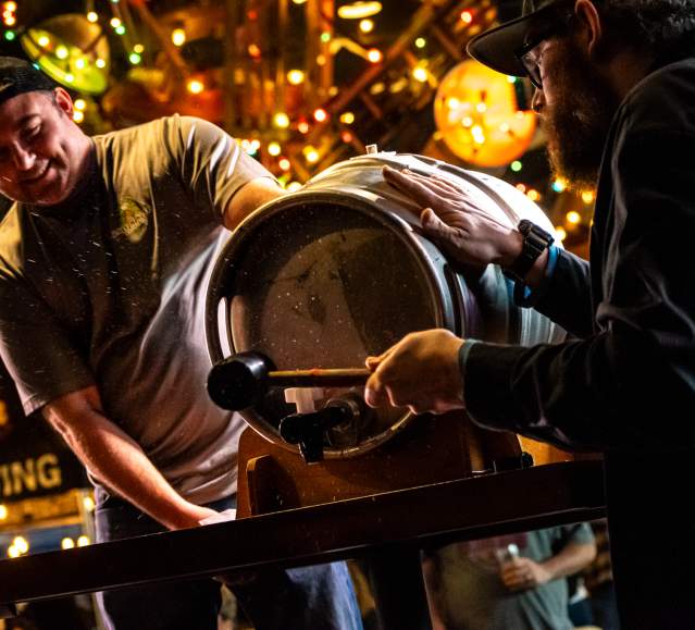 men opening a beer keg at Brewfest at Montage Mountain Resorts